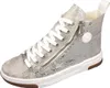 A silver high-top sneaker with white laces and a side zipper. Voir les images du produit