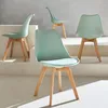 Four mint green Scandinavian-style chairs with wooden legs are arranged on a tiered white and gray platform. Produktbild-Vorschau