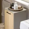 A bathroom cabinet with a laundry hamper and toiletries on top. Produktbild-Vorschau