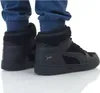 A close-up view of a pair of black Puma high-top sneakers worn by someone wearing blue pants. Produktbild-Vorschau