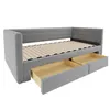 A gray upholstered daybed with two open drawers underneath, showing the wooden slats of the bed frame. Produktbild-Vorschau