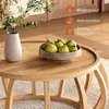 A round wooden coffee table with a bowl of pears and a vase of flowers on it, with feature icons in the background. Anteprima dell’immagine prodotto