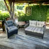 Outdoor furniture on a wooden deck with lush greenery in the background. Produktbild-Vorschau