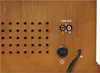 Close-up view of the back panel of a retro-style audio device, showing various ports and controls. Náhled obrázku produktu