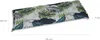 A long, rectangular cushion with a tropical leaf pattern, shown from a diagonal angle. Produktbild-Vorschau