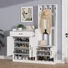 A white entryway organizer set with a coat rack, shoe cabinets, and a drawer, displayed in a room setting with a wall painting and a plant. Produktbild-Vorschau