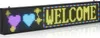 A programmable LED display panel showing the word "WELCOME" and two hearts. Produktbild-Vorschau