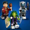 Three LEGO Marvel minifigures are displayed against a blue, speckled background. Náhled obrázku produktu