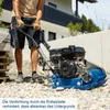 A person is using a plate compactor on a gravel surface next to a building. Podgląd zdjęcia produktu