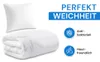 A white pillow and a folded white comforter are shown on a white background. Text overlays describe product features. Produktbild-Vorschau