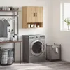 A laundry room scene with a washing machine, cabinet, and laundry basket. Voir les images du produit