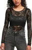 A woman wearing a black lace long-sleeve bodysuit and grey jeans. Produktbild-Vorschau