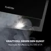 A close-up shot of a black kitchen hood with a light illuminating smoke, suggesting its effectiveness in clearing fumes. Text overlays highlight its power and performance. Produktbild-Vorschau