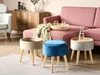 A living room scene with a pink sofa, a wooden cabinet, and three stools, one of which is blue. Náhľad obrázku produktu