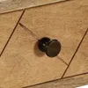 A close-up of a wooden drawer with a bronze knob. Anteprima dell’immagine prodotto