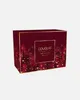 A red and gold advent calendar box with a forest and snow design. Produktbild-Vorschau