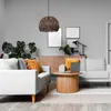 A living room scene with a hanging lamp, sofas, a coffee table, and decor. Anteprima dell’immagine prodotto