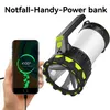 A hand holds a smartphone showing it is charging, next to a large flashlight/power bank. Produktbild-Vorschau