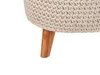 Close-up of the knitted texture and wooden leg of a hocker. Náhled obrázku produktu