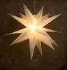 A lit-up, multi-pointed star decoration hanging against a textured brown background. Produktbild-Vorschau
