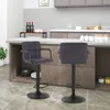 Two dark gray bar stools are placed in a modern kitchen setting, with a countertop and cabinets visible in the background. Produktbild-Vorschau