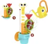 A Yookidoo snail and flower garden bath toy is shown in use, with water being poured from a yellow watering can into a funnel, causing a propeller to spin. The toy is designed for bath time fun. Podgląd zdjęcia produktu