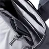 A close-up view of the interior of a backpack, showing zippered compartments and a key attached to a zipper pull. Náhľad obrázku produktu