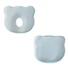 Two baby pillows shaped like bear heads, one with a hole in the center and the other solid, are shown against a white background. Podgląd zdjęcia produktu