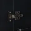 A close-up view of a cabinet hinge on a black surface. Anteprima dell’immagine prodotto
