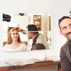 A man is cutting a woman's hair in front of a wall with mirrored tiles. Anteprima dell’immagine prodotto