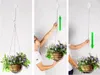 A triptych showing how to use a retractable hanging basket hook. The left panel shows the hook with a hanging basket. The middle panel shows a person pulling the hook upwards to raise the basket. The right panel shows a person pulling the hook downwards to Náhled obrázku produktu