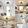 Collage of four images showing a modern black Sputnik ceiling light fixture in different room settings: a hallway, a living room, a bedroom, and a kitchen. Voir les images du produit