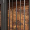 A close-up view of a dog crate with metal bars and a wooden background. Produktbild-Vorschau