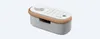 A product shot of a white Sony speaker with a tan trim, set against a plain white background. Voir les images du produit