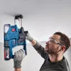 A man is drilling a hole in the ceiling with a power drill. Produktbild-Vorschau