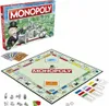 A Monopoly board game box and its contents are displayed on a white background. Produktbild-Vorschau