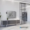 A modern office or living room setting with a TV mounted on the wall above a credenza. Produktbild-Vorschau