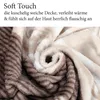 A close-up, swirled view of a soft, plush blanket with a beige and brown striped pattern. Produktbild-Vorschau
