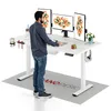A man stands at a white standing desk with multiple monitors, accessories, and a rug underneath. Podgląd zdjęcia produktu