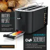 A black toaster with a bun rack attachment and a crumb tray extended, set against a background of bread rolls. Náhľad obrázku produktu