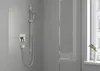 A modern bathroom shower with a handheld showerhead and controls mounted on a gray tiled wall. Náhľad obrázku produktu