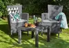 A garden furniture set with two chairs and a table on a lawn. Produktbild-Vorschau