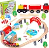 A wooden train track set for children, including a train, wagons, bridge, and various accessories, laid out on a white background. Produktbild-Vorschau