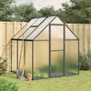 A greenhouse with gardening tools in a backyard setting. Náhled obrázku produktu