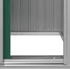 A close-up view of the lower section of a green and gray storage shed, showing the bottom of the door opening and the track it slides on. Produktbild-Vorschau