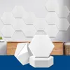 A display of hexagonal acoustic panels, some mounted on a wall and others stacked in the foreground. Produktbild-Vorschau