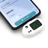 A digital thermometer next to a smartphone displaying an online shopping interface. Produktbild-Vorschau