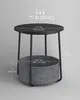 A round side table with a grey fabric basket underneath, shown with measurements and weight capacity. Náhled obrázku produktu