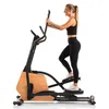 A woman is using an elliptical trainer. Podgląd zdjęcia produktu