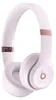 A pair of white and rose gold Beats Solo4 wireless headphones is shown against a white background.